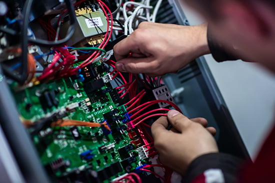 Electro-mechanical assembly with integrated PCBA and wiring harness